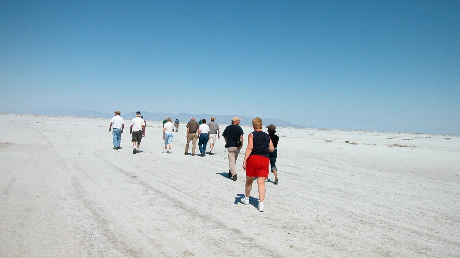 People walk in a vast salt flat.