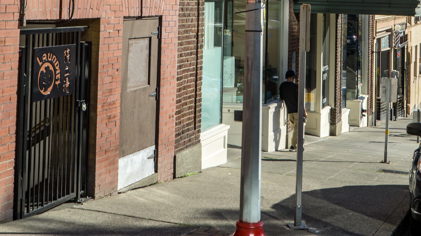 Street scene dominated by old brick buildings with a vintage hotel sign prominently visible.