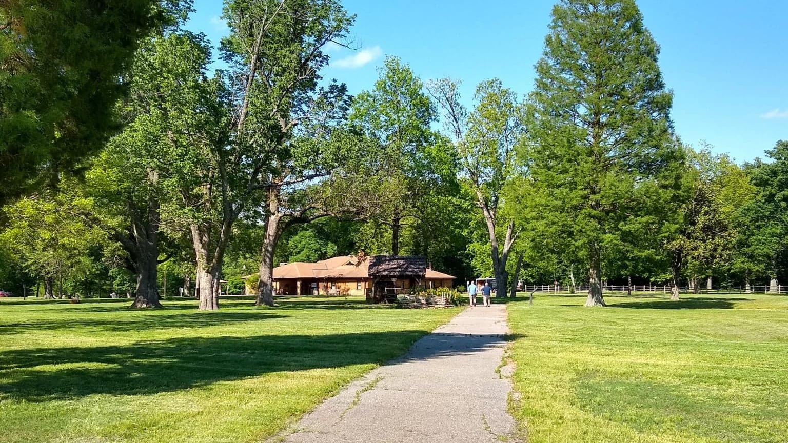 Wide gravel path leading to a large visitor center