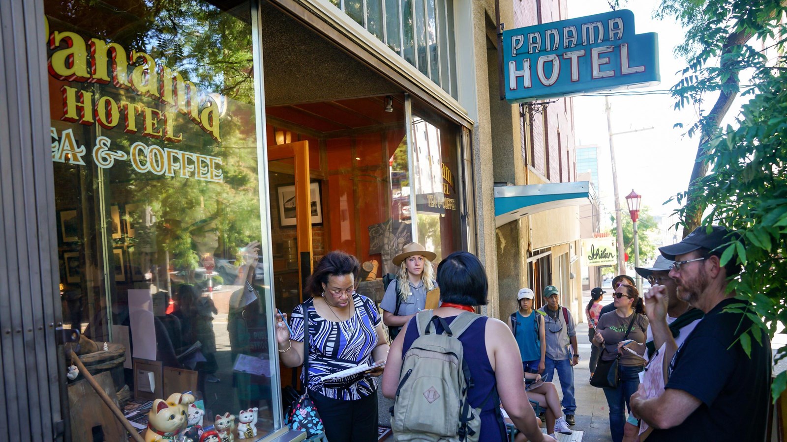 A group of individuals interacting and moving about, with hotel signage prominently displayed.