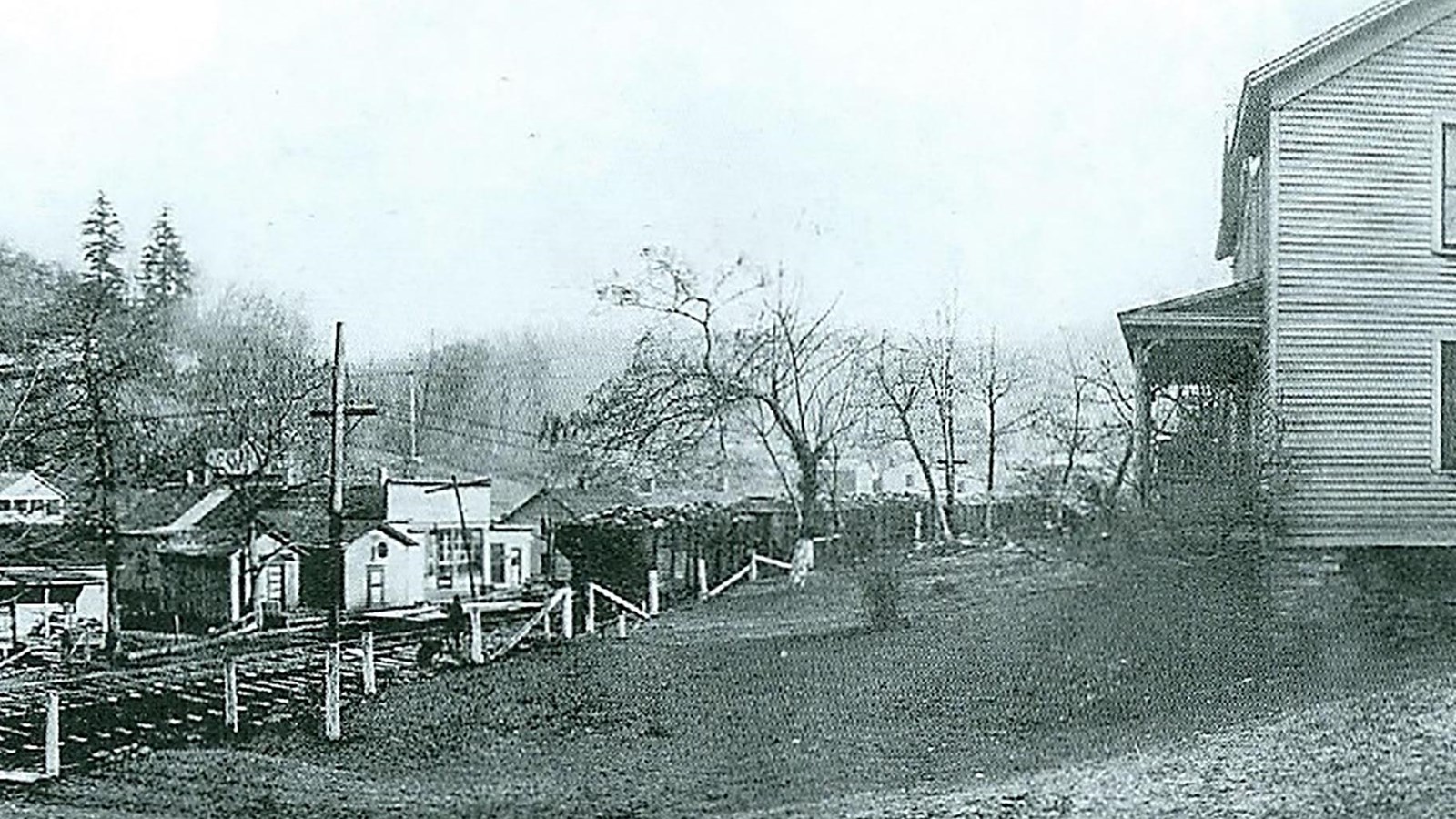 Historical black and white photo of a small town with houses