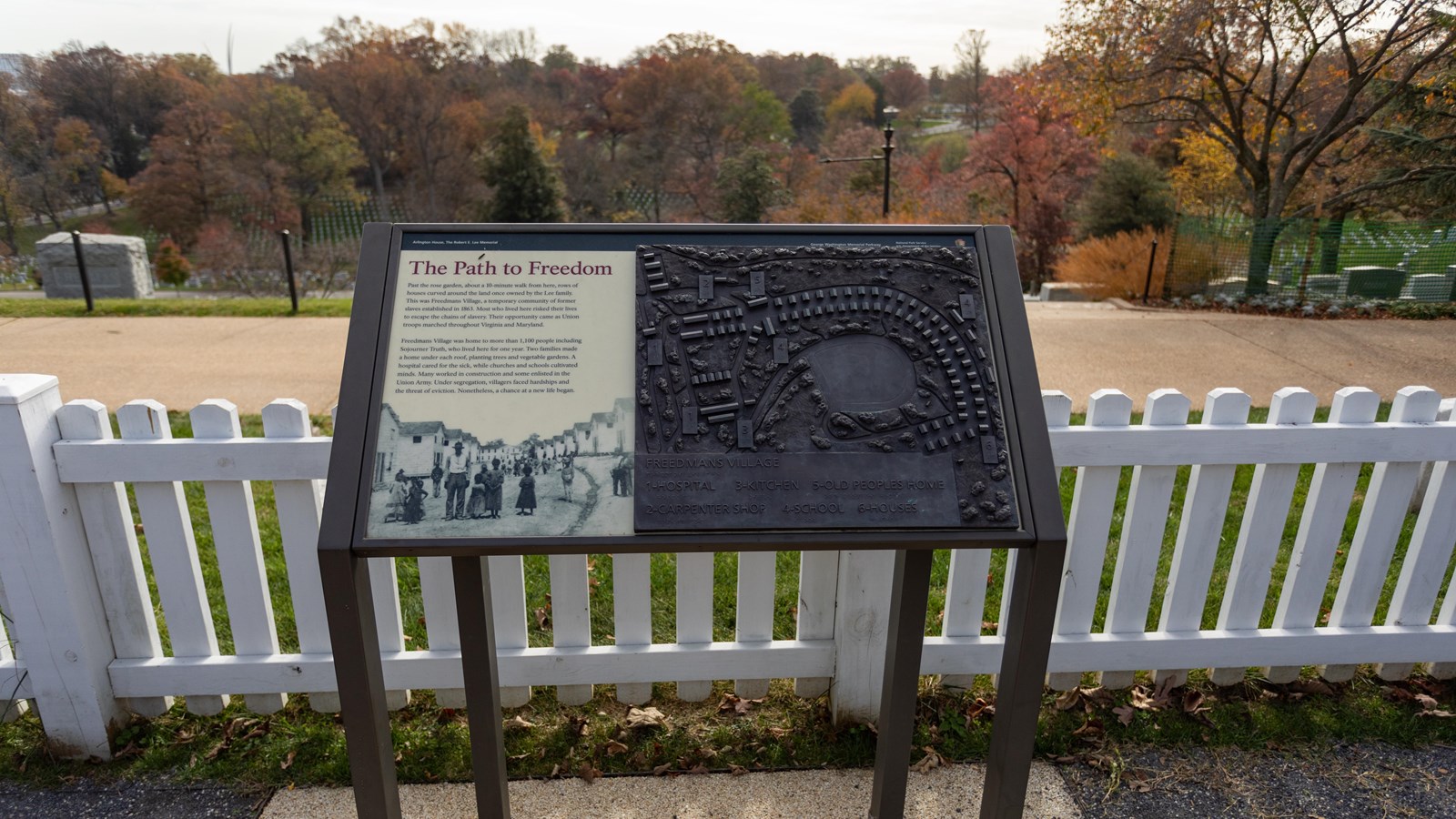 An exhibit panel overlooks Arlington Cemetery. A tactile map is on the right side of the panel.