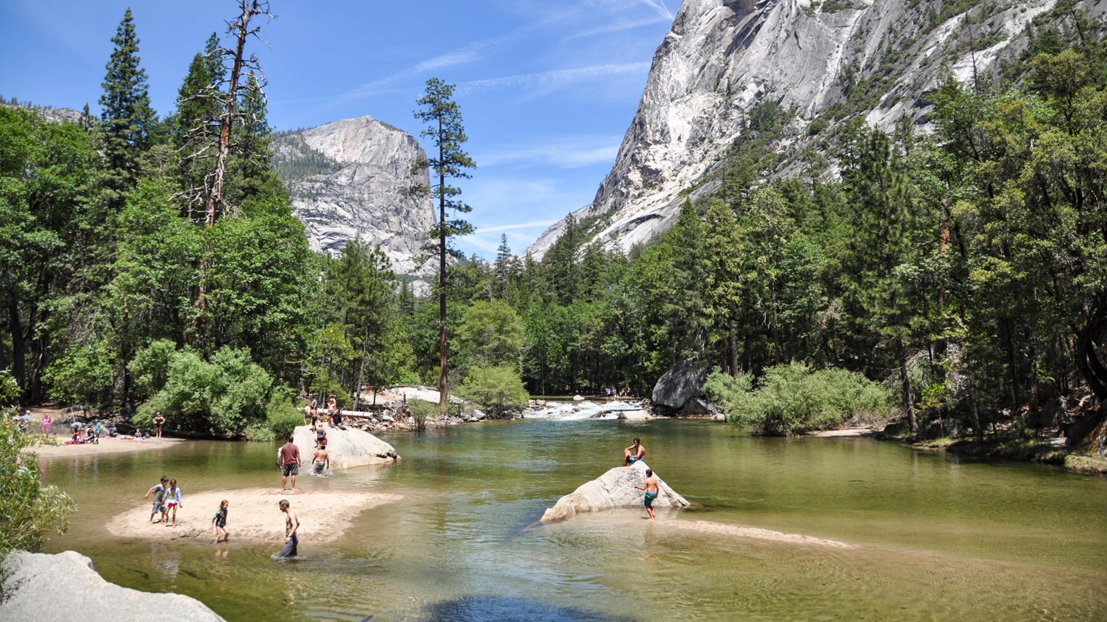 Low water levels in Mirror Lake with people wading into water