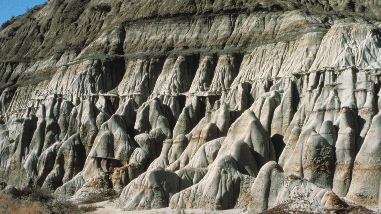 A rock face eroding at different rates