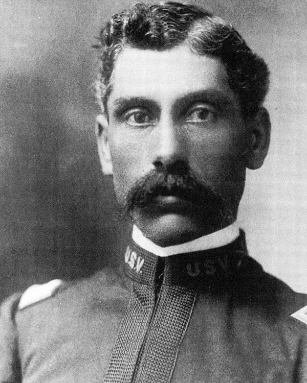 Black and White photo of African American Man in military uniform. He has a bark colored mustache.
