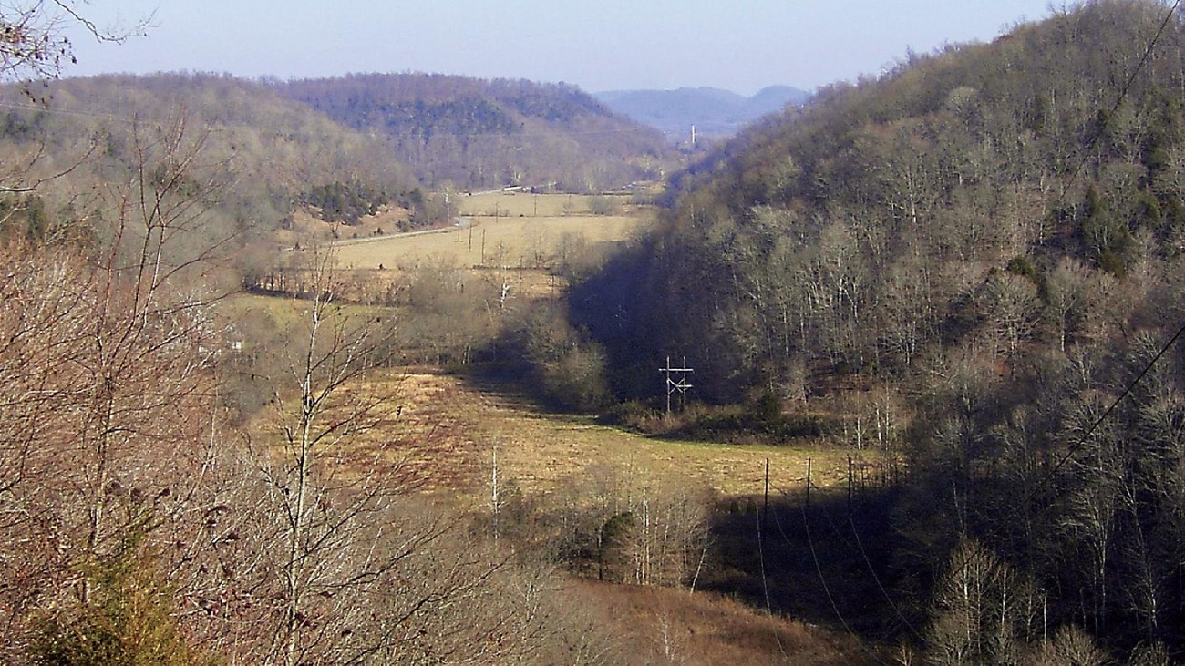 view of Knob Creek surrounded by trees and fields.
