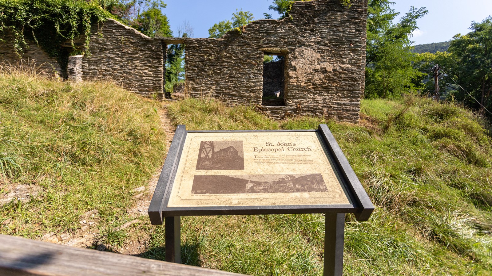 Exhibit panel with historic photos of stone church and title 