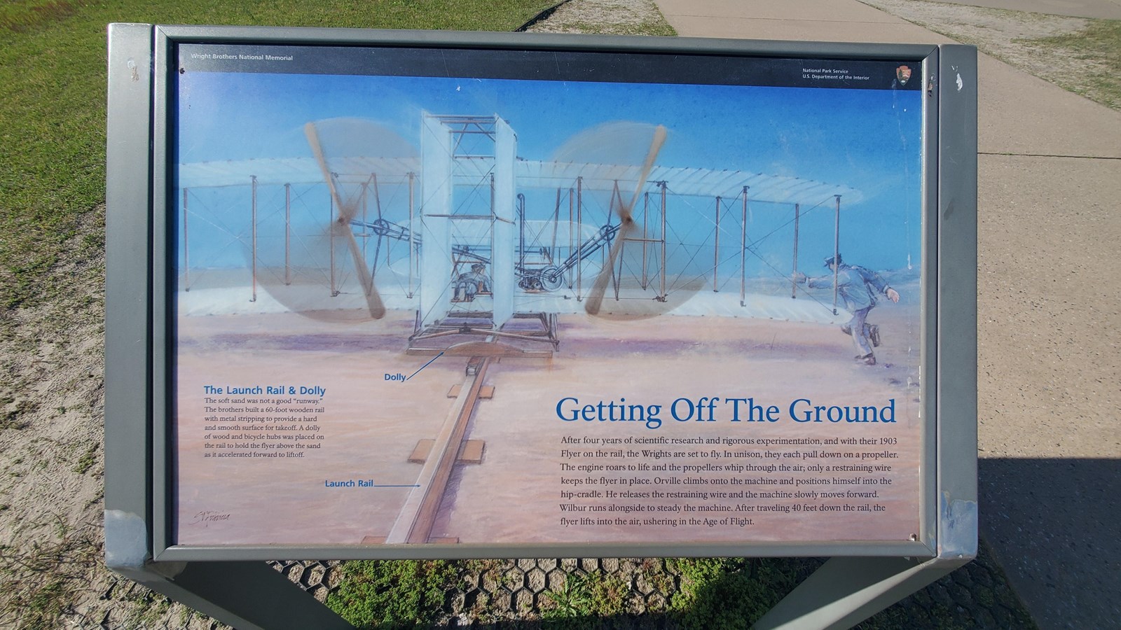Colored photograph of the Getting Off the Ground wayside that is outside