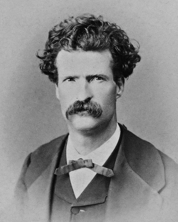 Black and White head and shoulder's portrait facing front, wearing a suit and bowtie