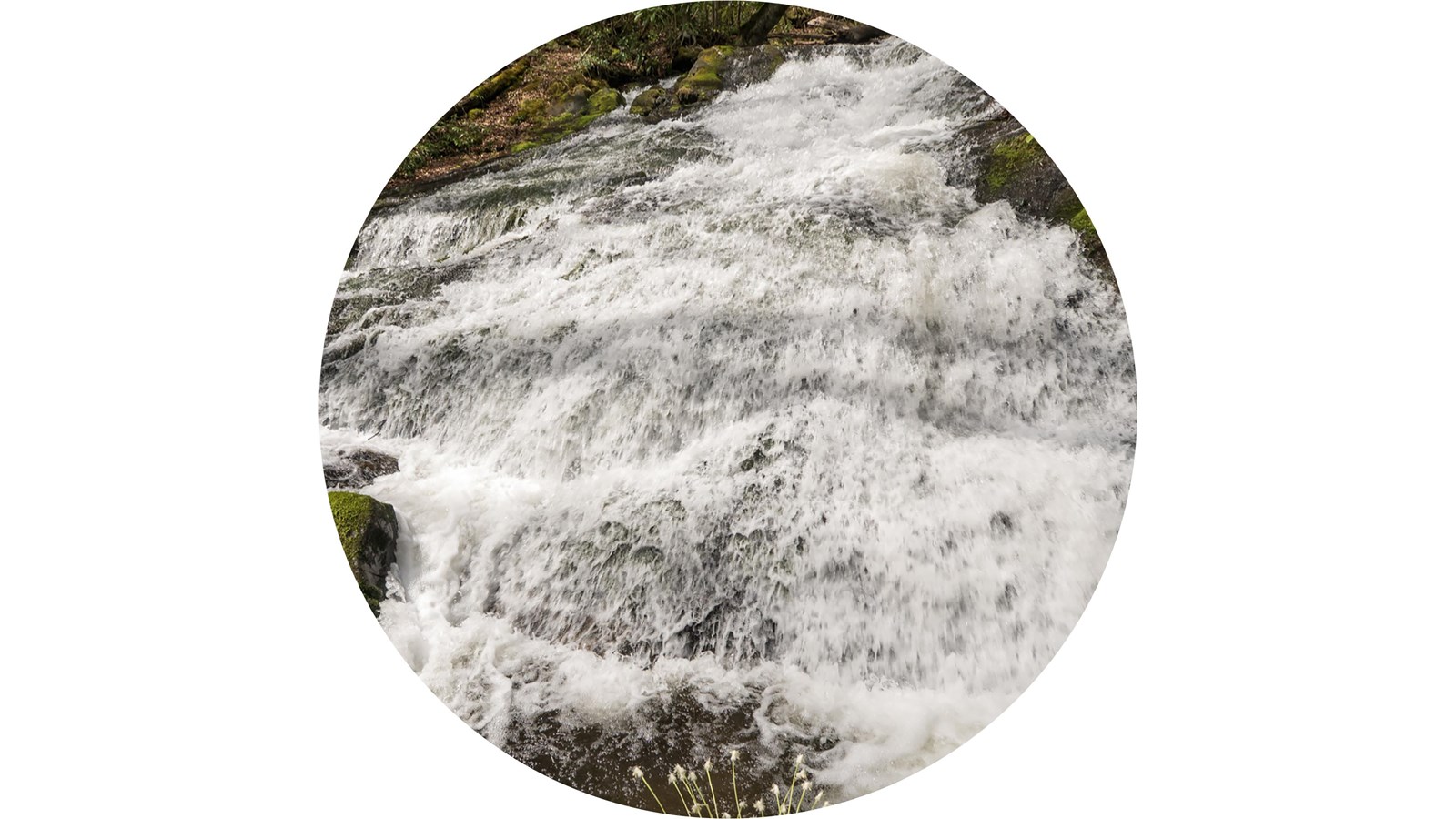 A wide cascade runs down rocks.
