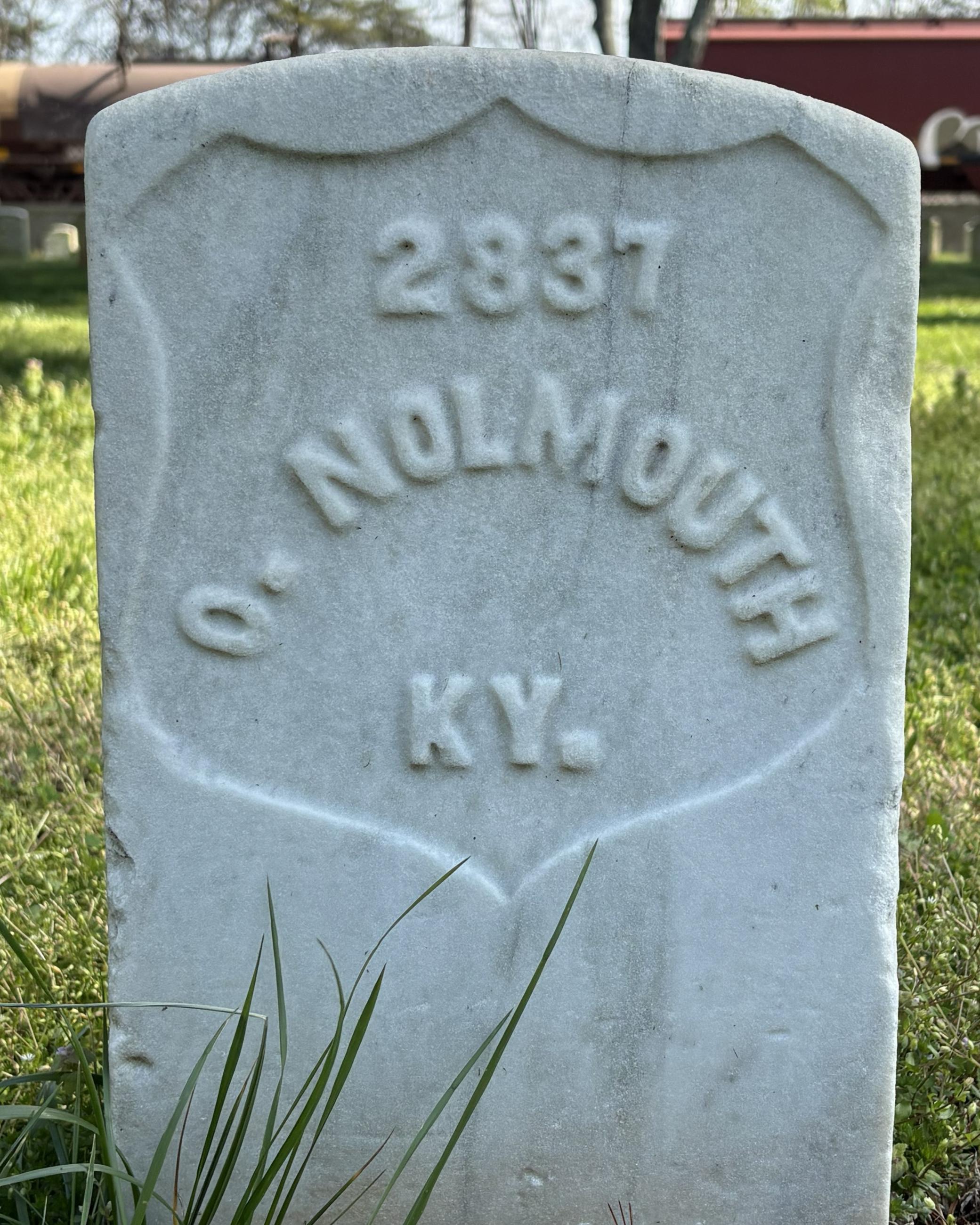 Marble headstone with the name "O. Nouldmouth" inscribed on it. 