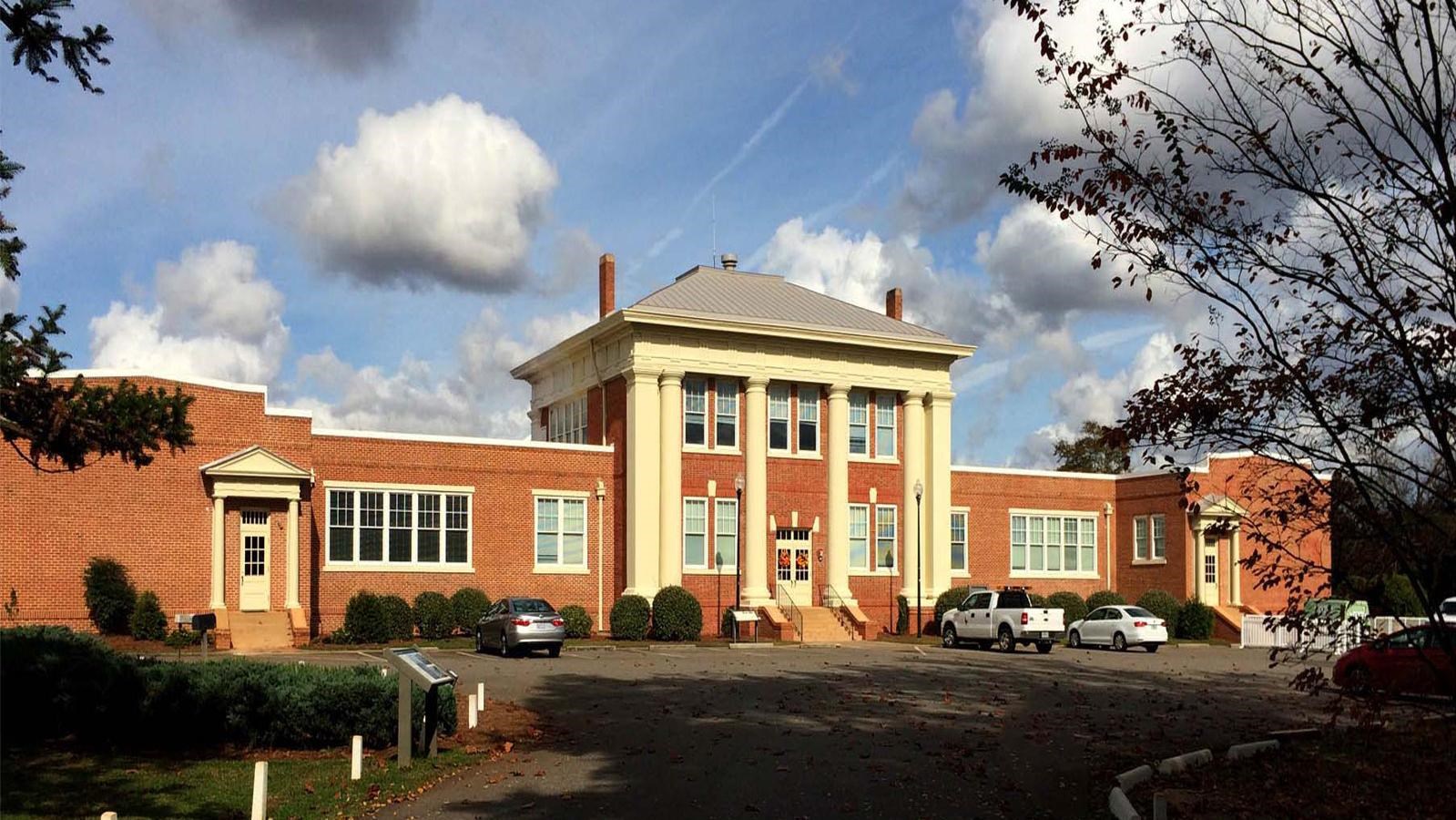 Plains High School is a red brick building with large columns at the top of stairs