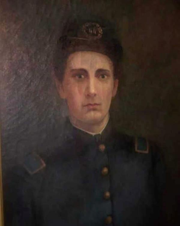 Young man wearing a Union Infantry uniform and posing for a painted photo.