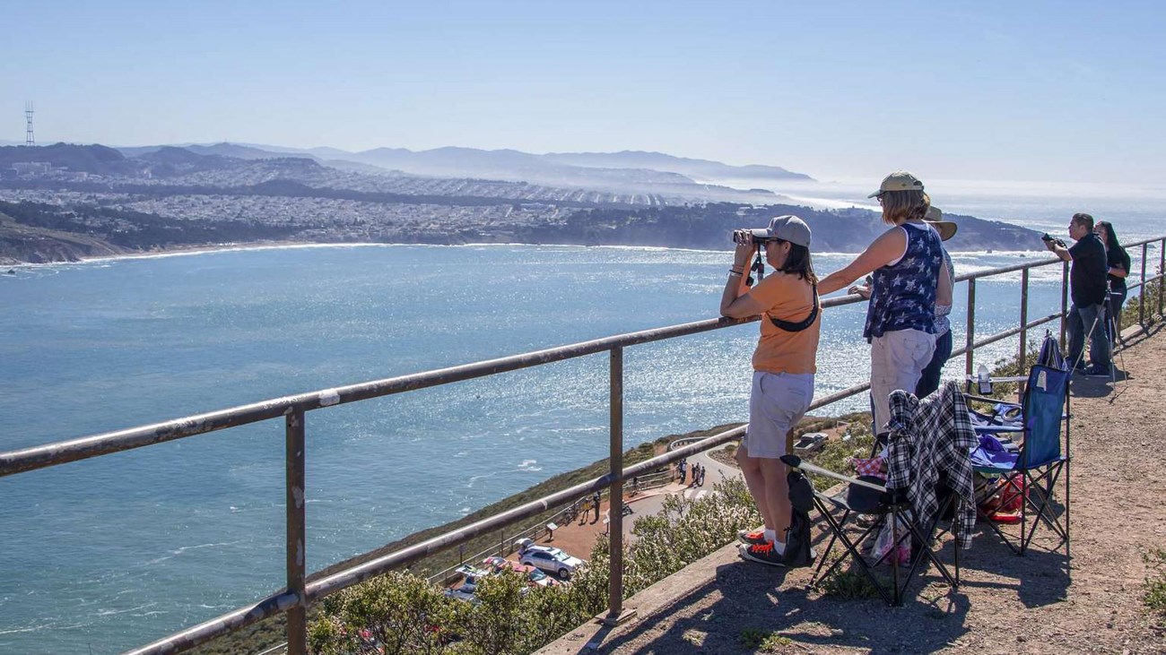 Visitors looking for birds from the Hawk Hill Overlook.