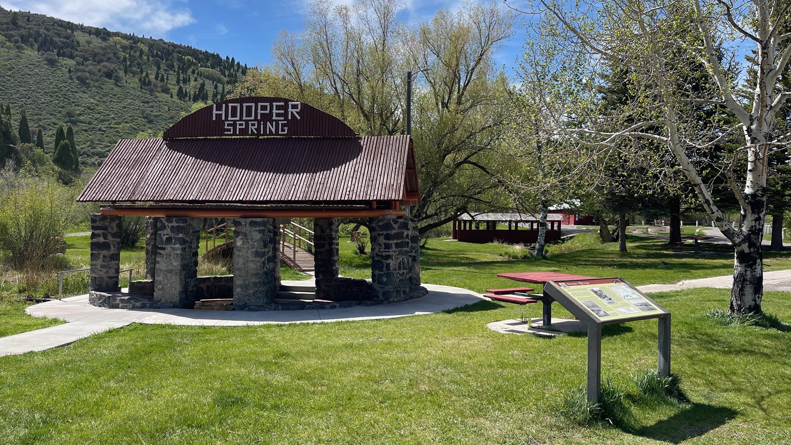 Stone pillars support a roof over bubbling “Beer Spring” at Hooper Spring Park, Soda Springs, Idaho.