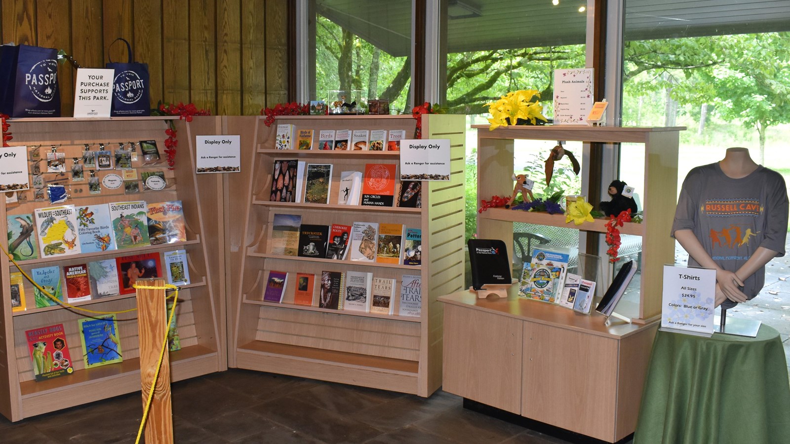 Shelve sit with books and collectables, a t-shirt is on a mannequin