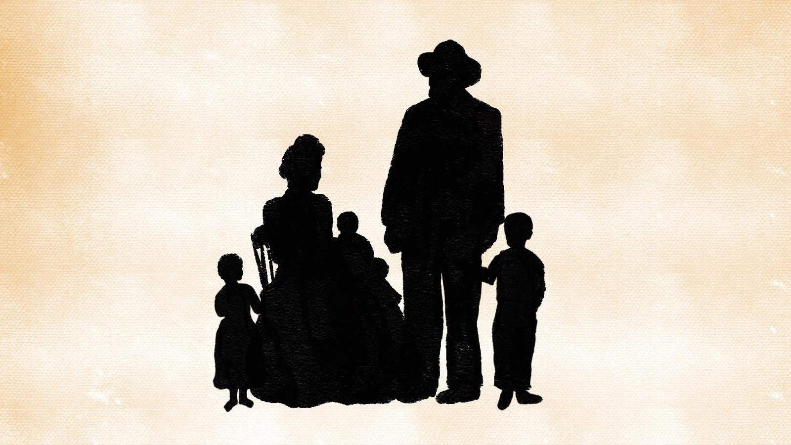 A family of five stand and sit next to each other. They are portrayed in silhouette form.