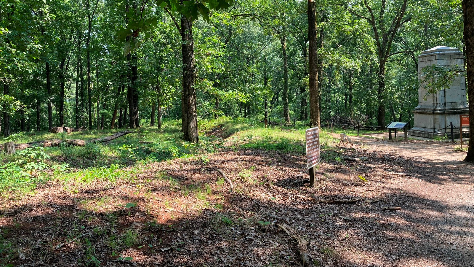 Picture shows a wide dirt trail sweeping off at an angle to the rear left.