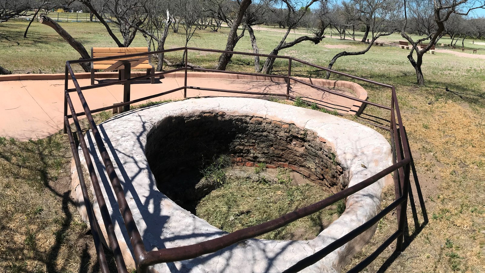 circular pit about six feet deep, coated in limestone plaster