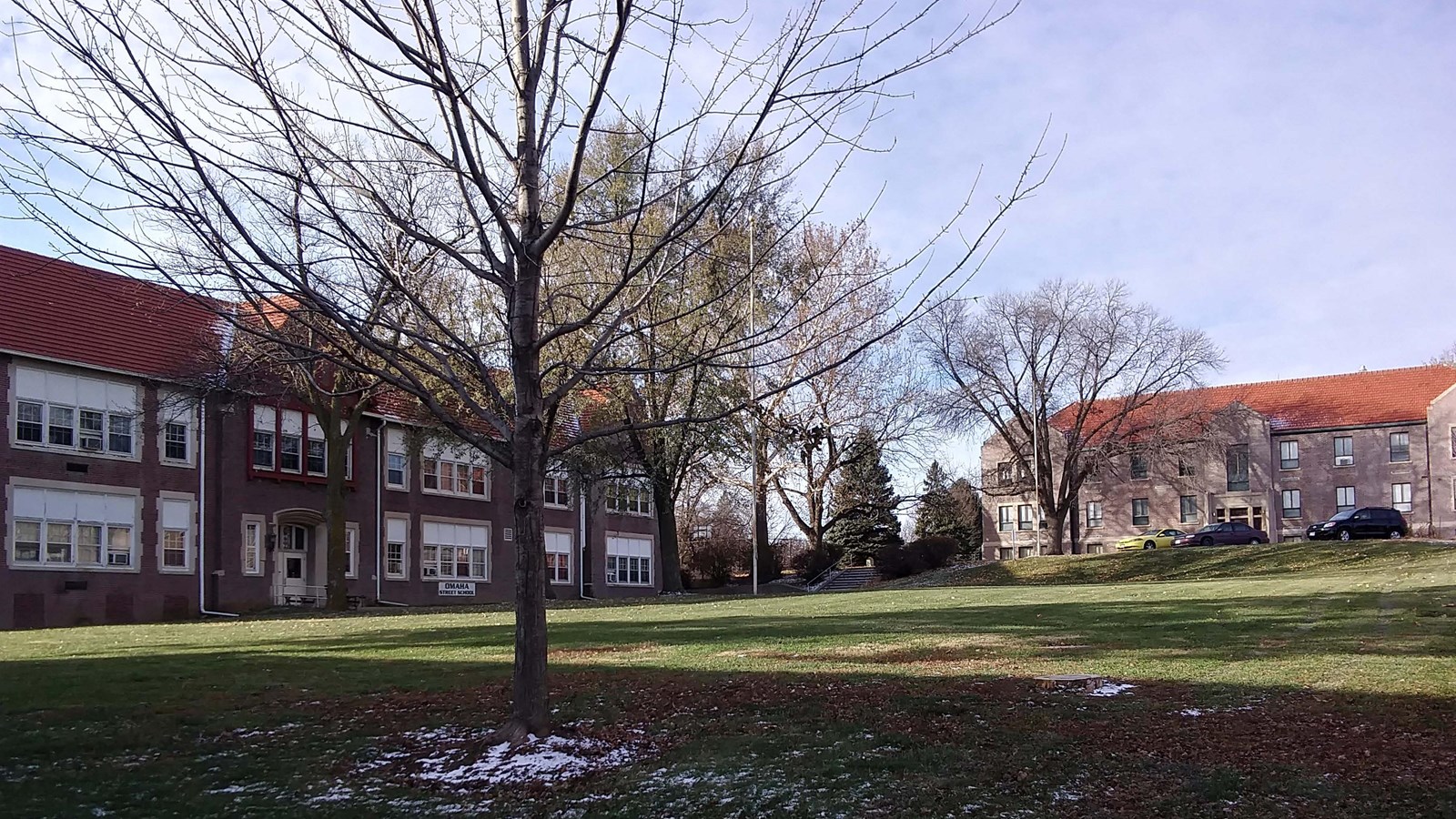 Quad of the campus showing buildings on two sides of an open green area