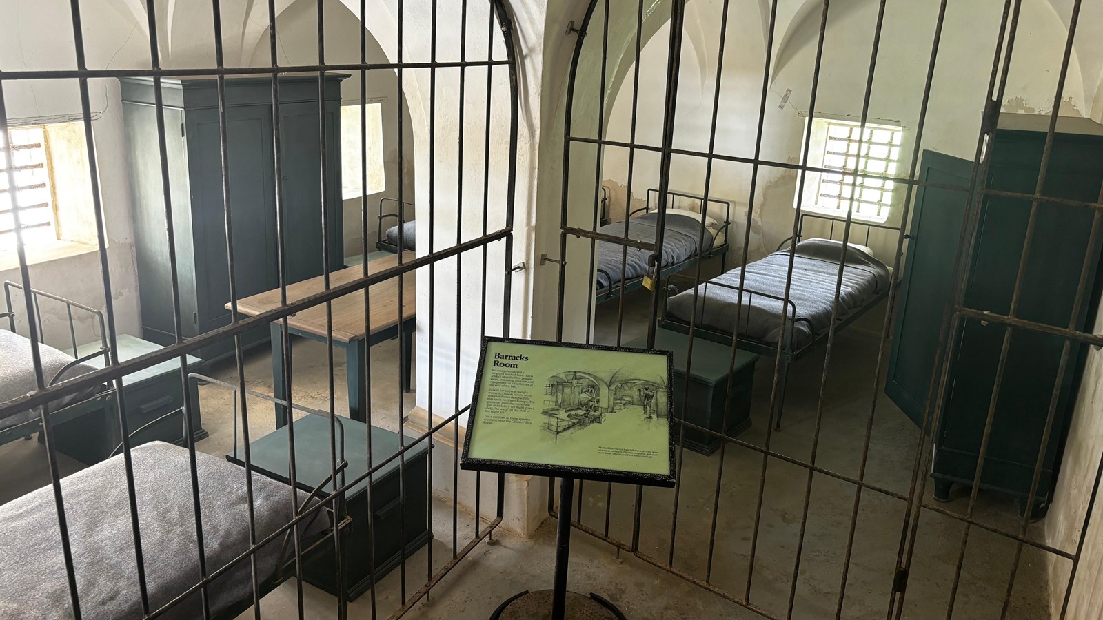 photo of a room with bars and 5 cots.