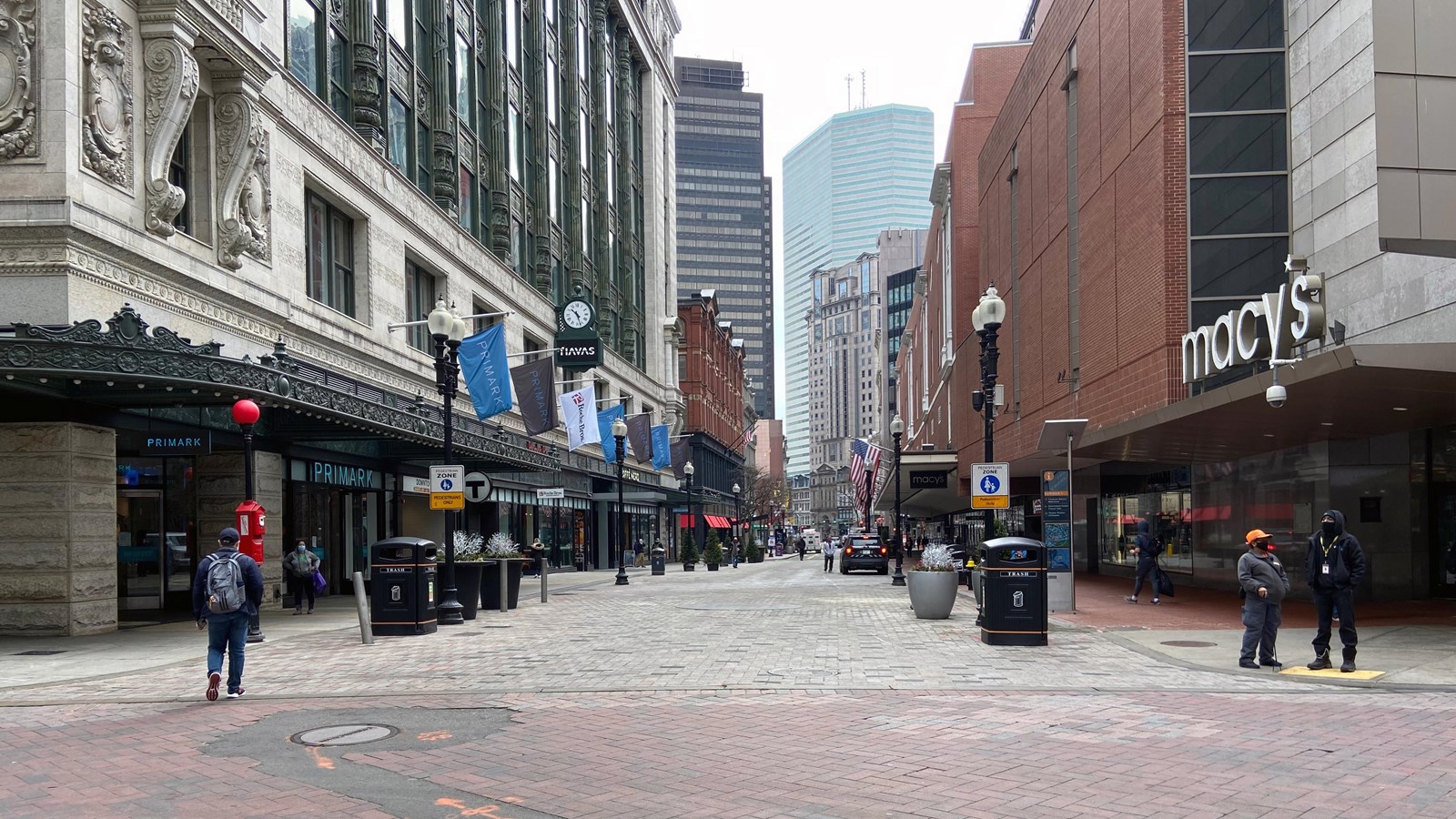 Cross street with department stores on each side of the street.