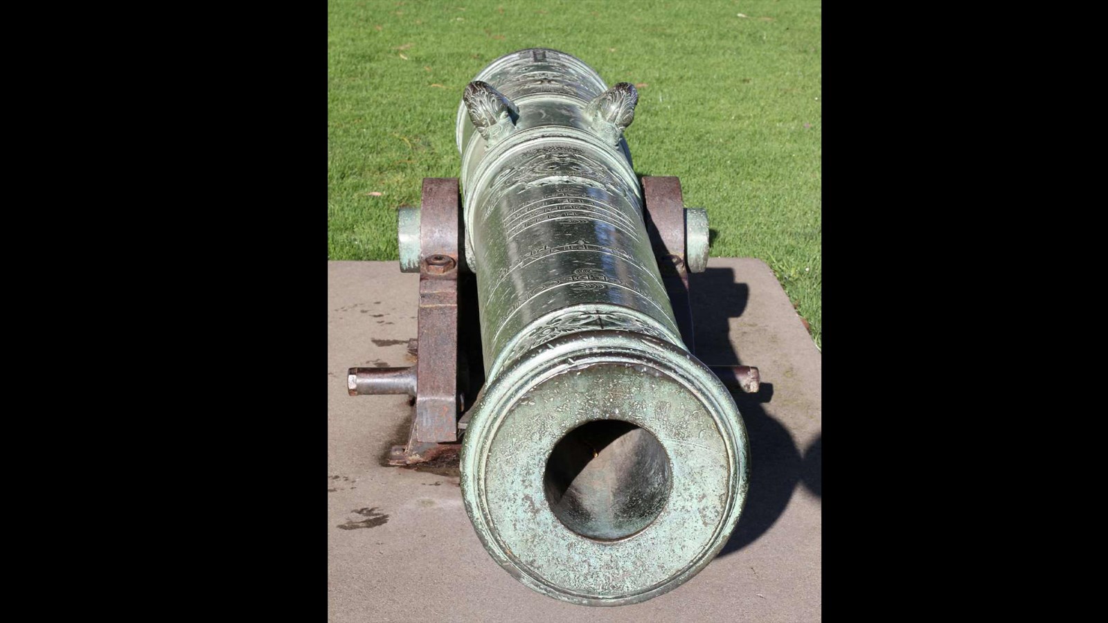 Looking down the barrel of a patinaed cannon.