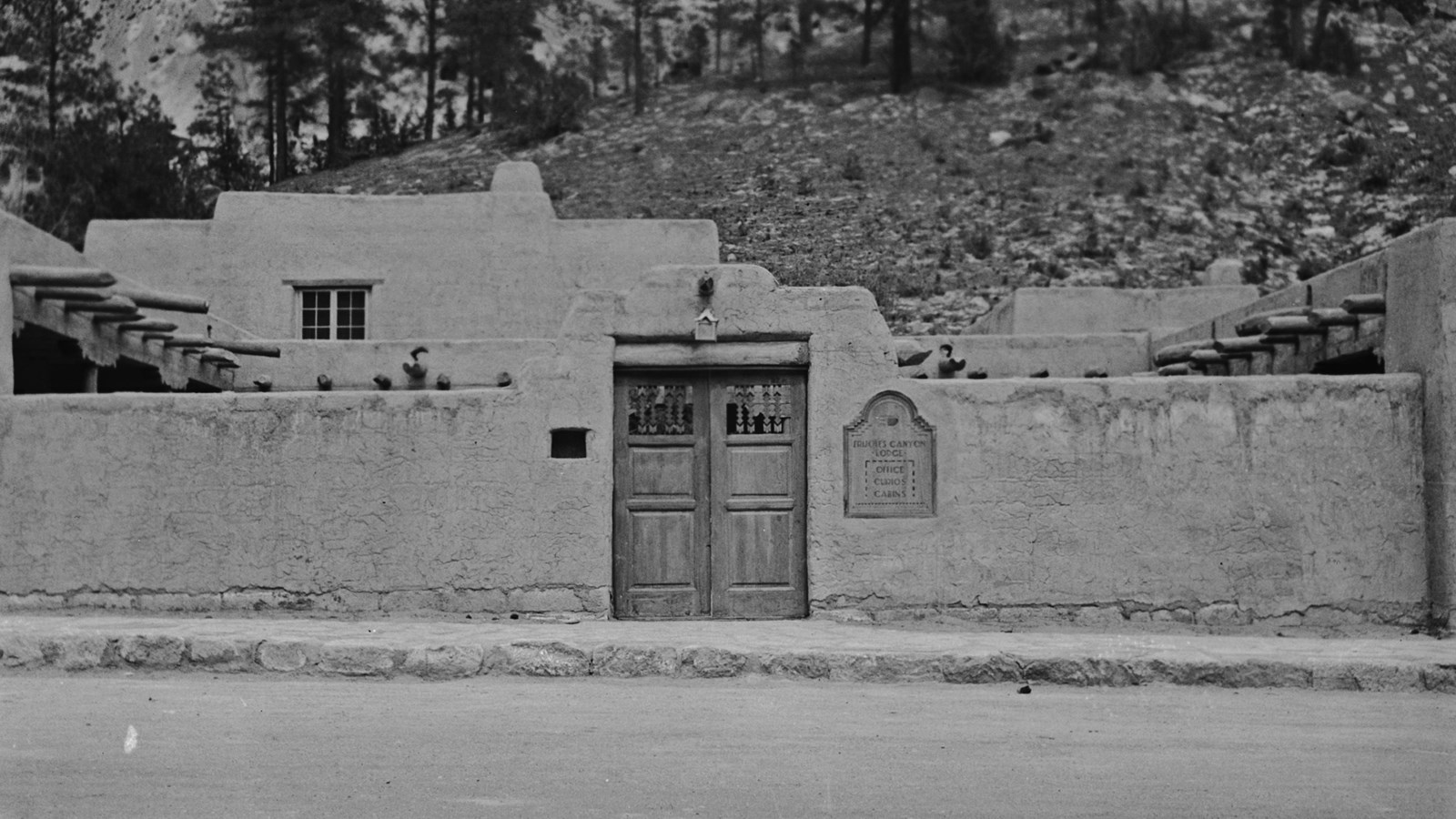 a stone wall with a wooden double door