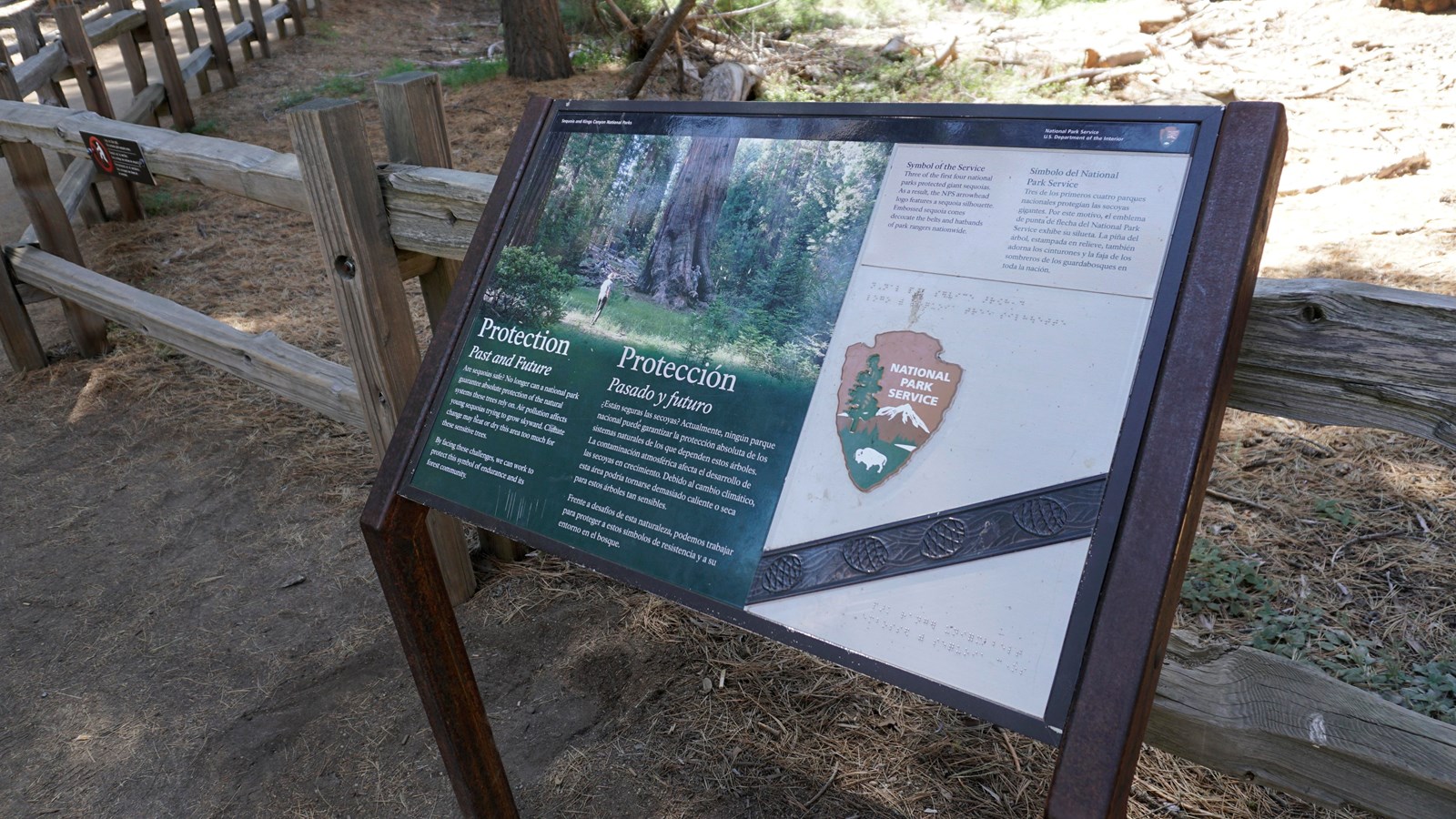 A metal panel sits in a metal frame. On the metal panel are text and images.