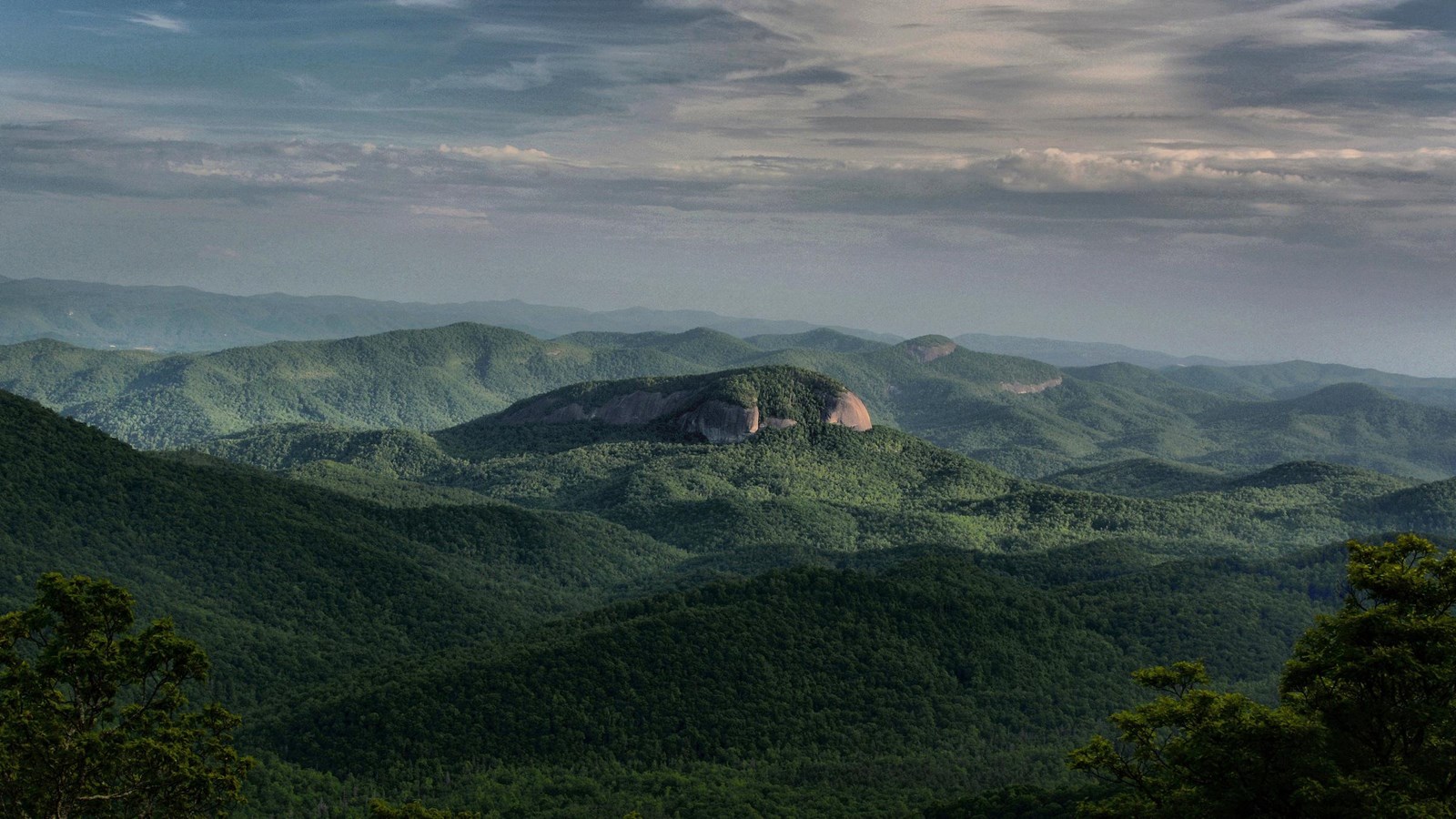 Mountains with sunlight illuminating bare rock face