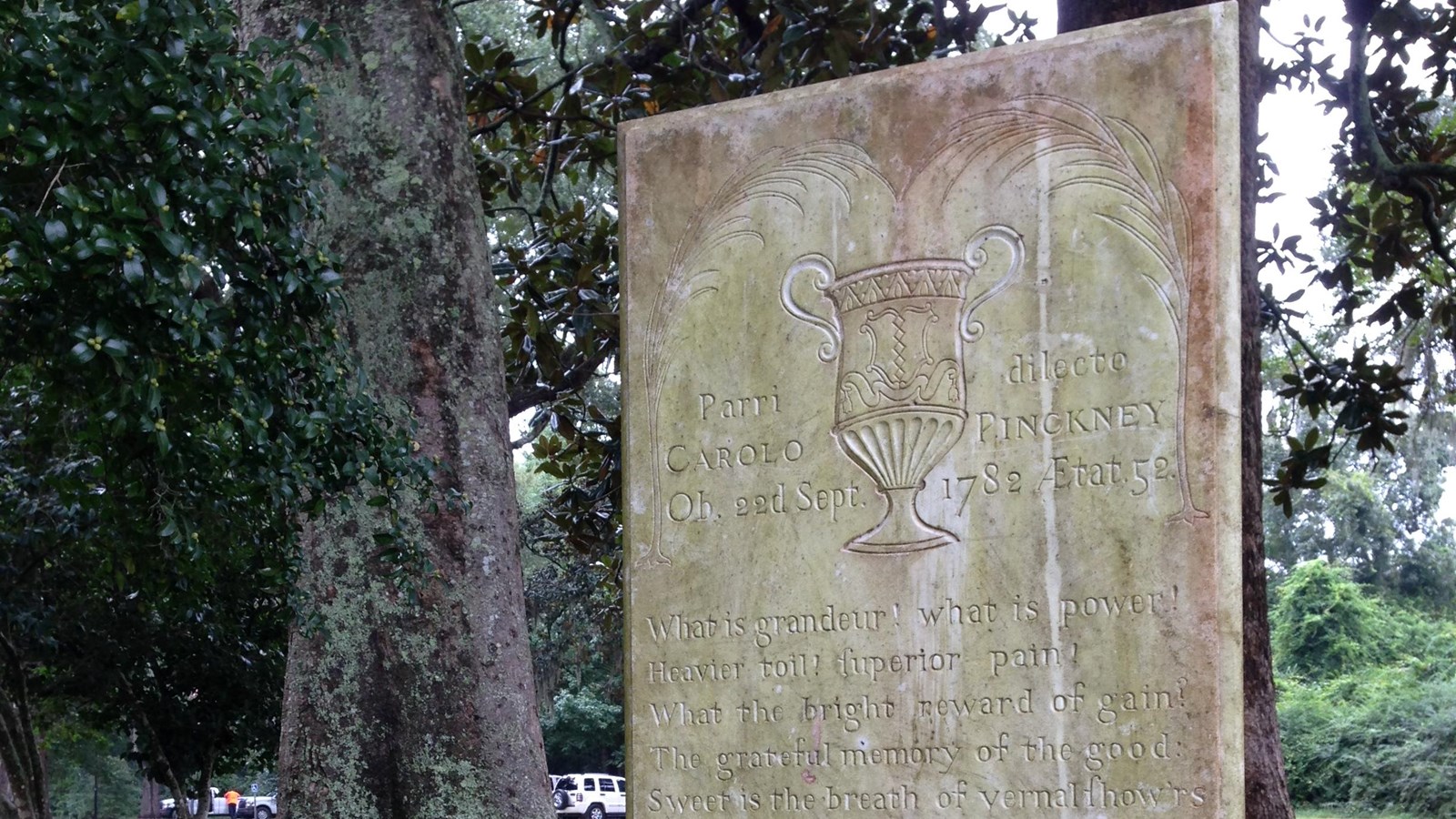 Engraved marble slab standing in the middle of a grove of live oaks