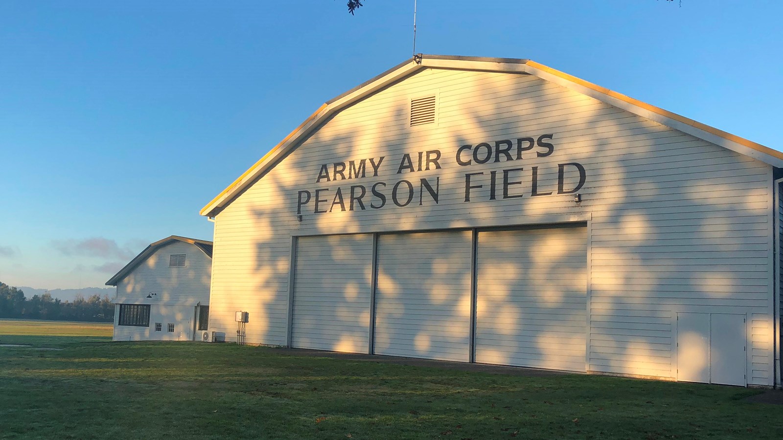 A white airplane hangar with the words