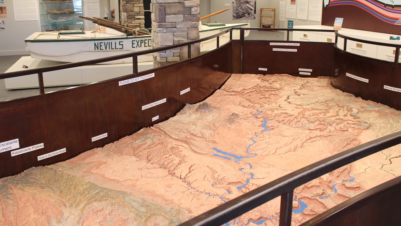 Relief map depicting desert landscape with a man-made lake. Metal railings