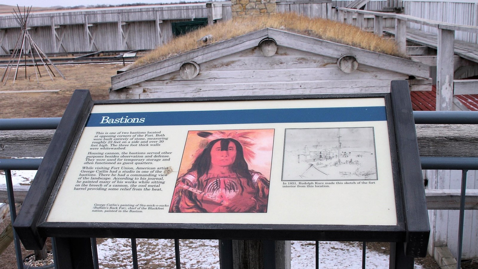 Panel: painting of American Indian and sketch of the Courtyard. Background: wooden buildings & wall