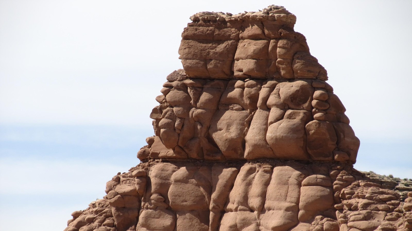 A large, tall formation of rock