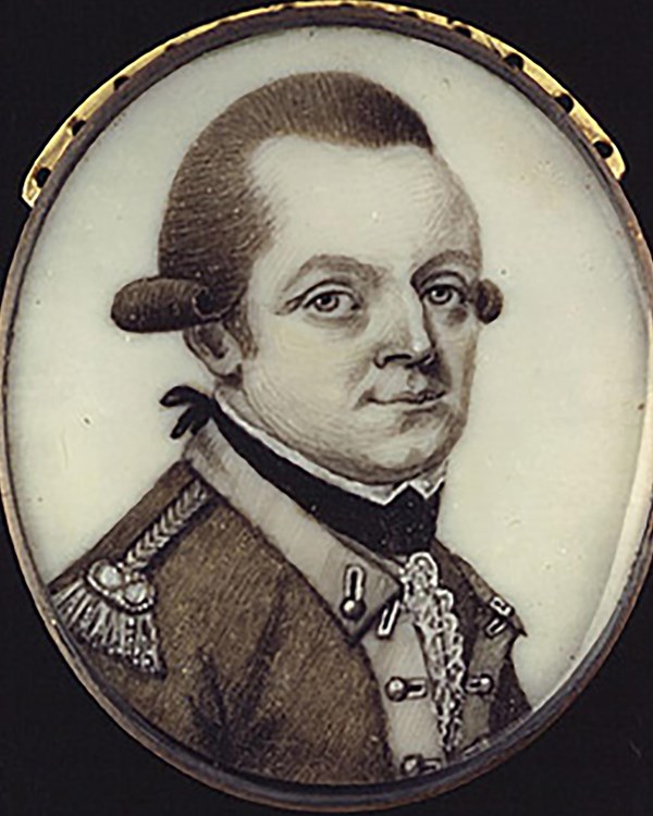 A man with a dramatic widow's peak hairline in profile, wearing an 18 C military-style jacket.
