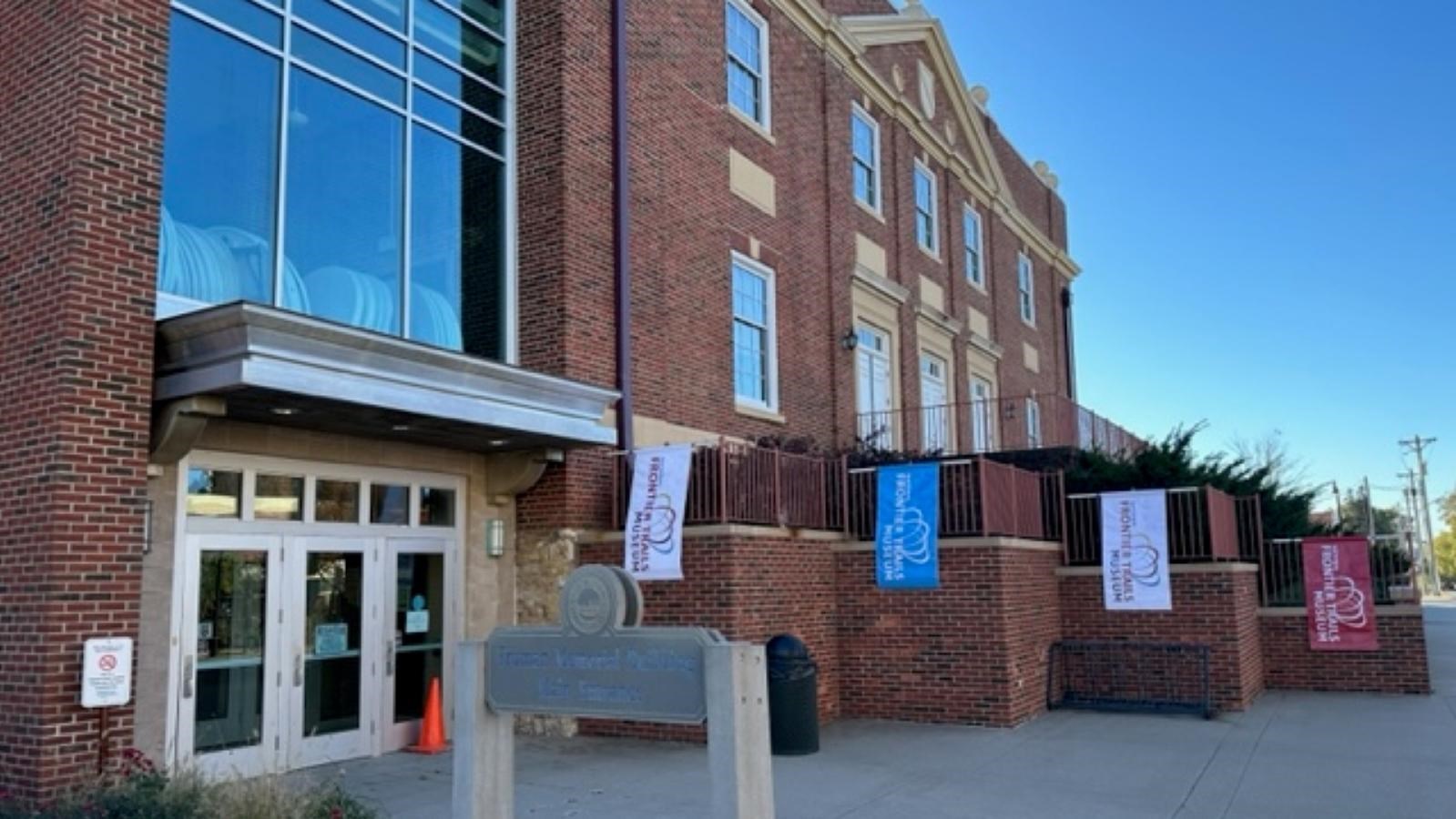 The front entrance to a large, red brick building.