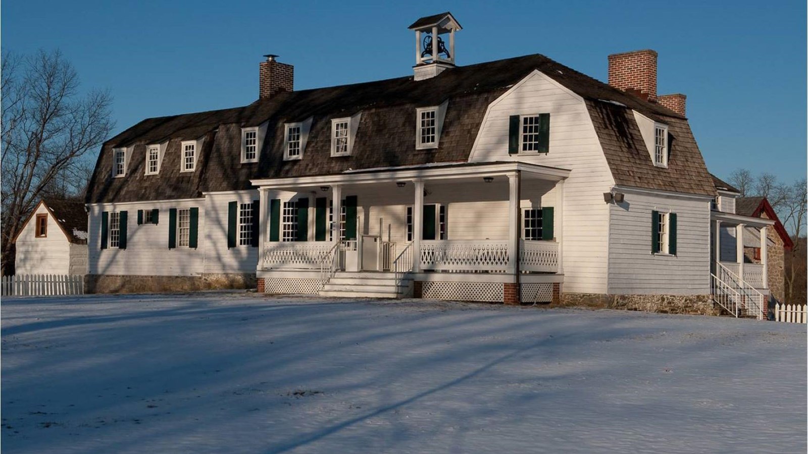 a view of the lower farm house in the snow