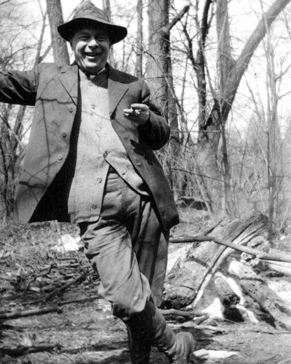 Black and white photograph of Professor Henry Chandler Cowles outdoors leaning with one arm on tree