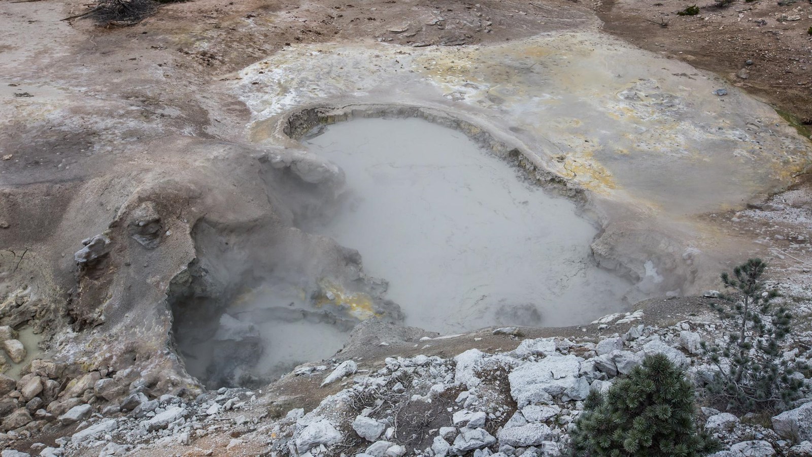 Looking down on a large mudpot in a thermal basin.