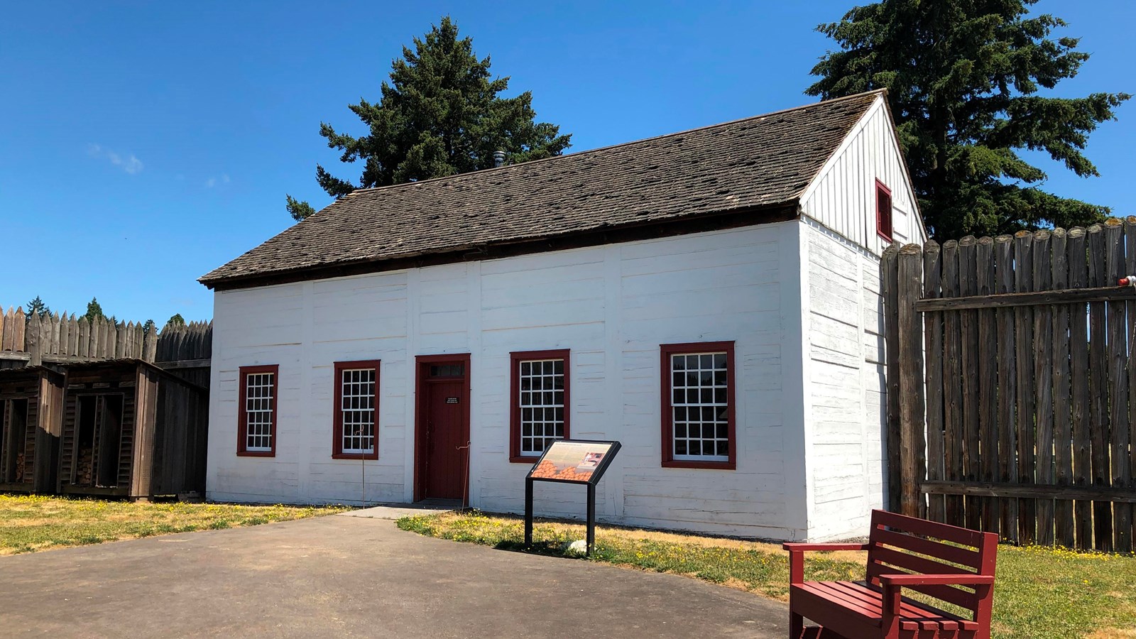 A white house with four windows and one door.