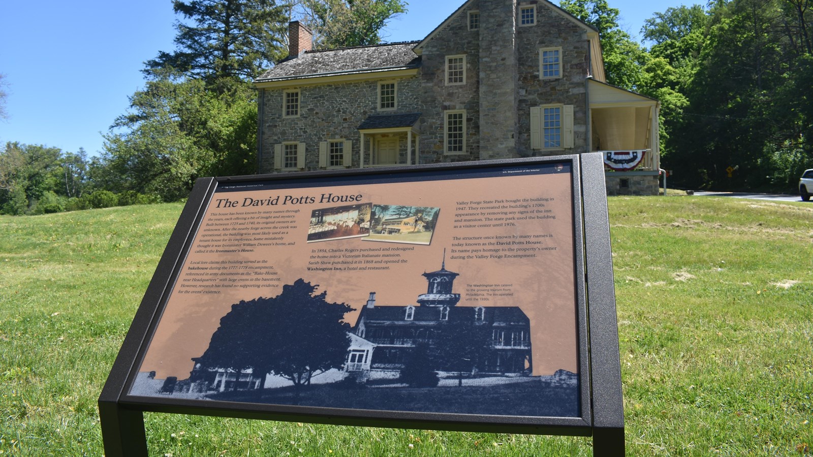 wayside exhibit panel showing historic photos of a large victorian building