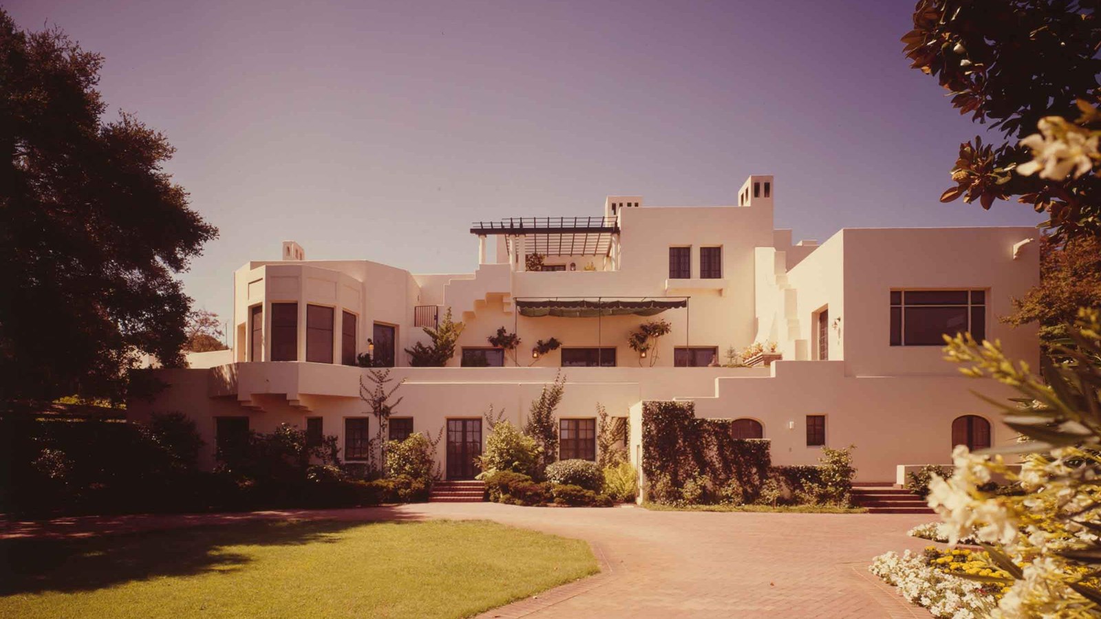 A huge international style house resembles beige blocks piled up.