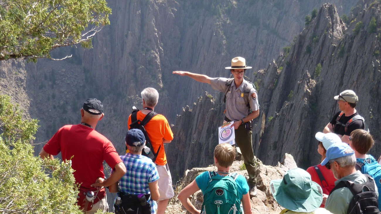 A ranger leads a group of visitors on a geology walk.