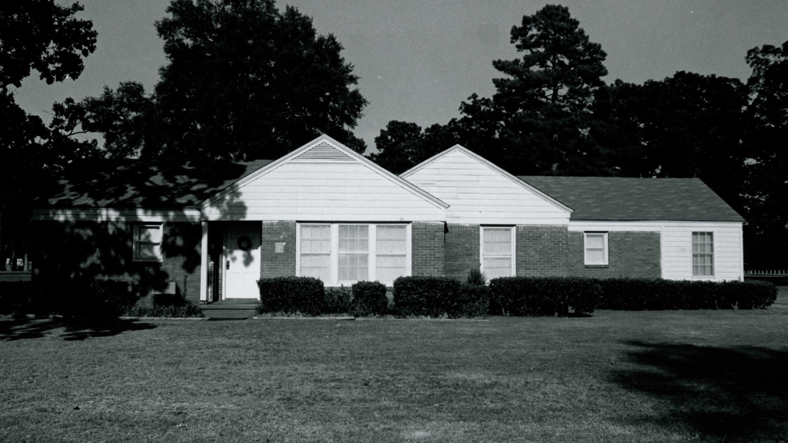 One-story ranch style house with a low-pitched, gabled roof with composition shingles and the w