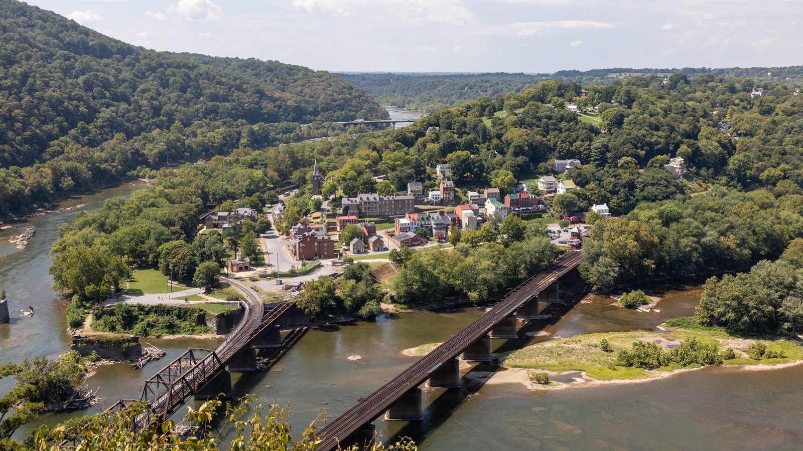 Elevated view of Harpers Ferry, two rivers, and two railroad bridges.