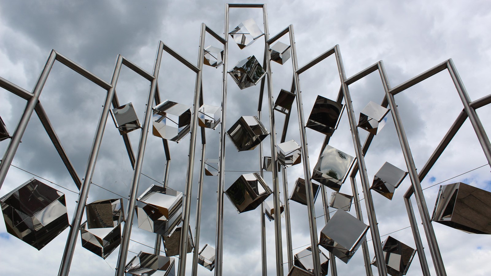 Tall metal sculpture featuring metal cubes in downtown Lowell