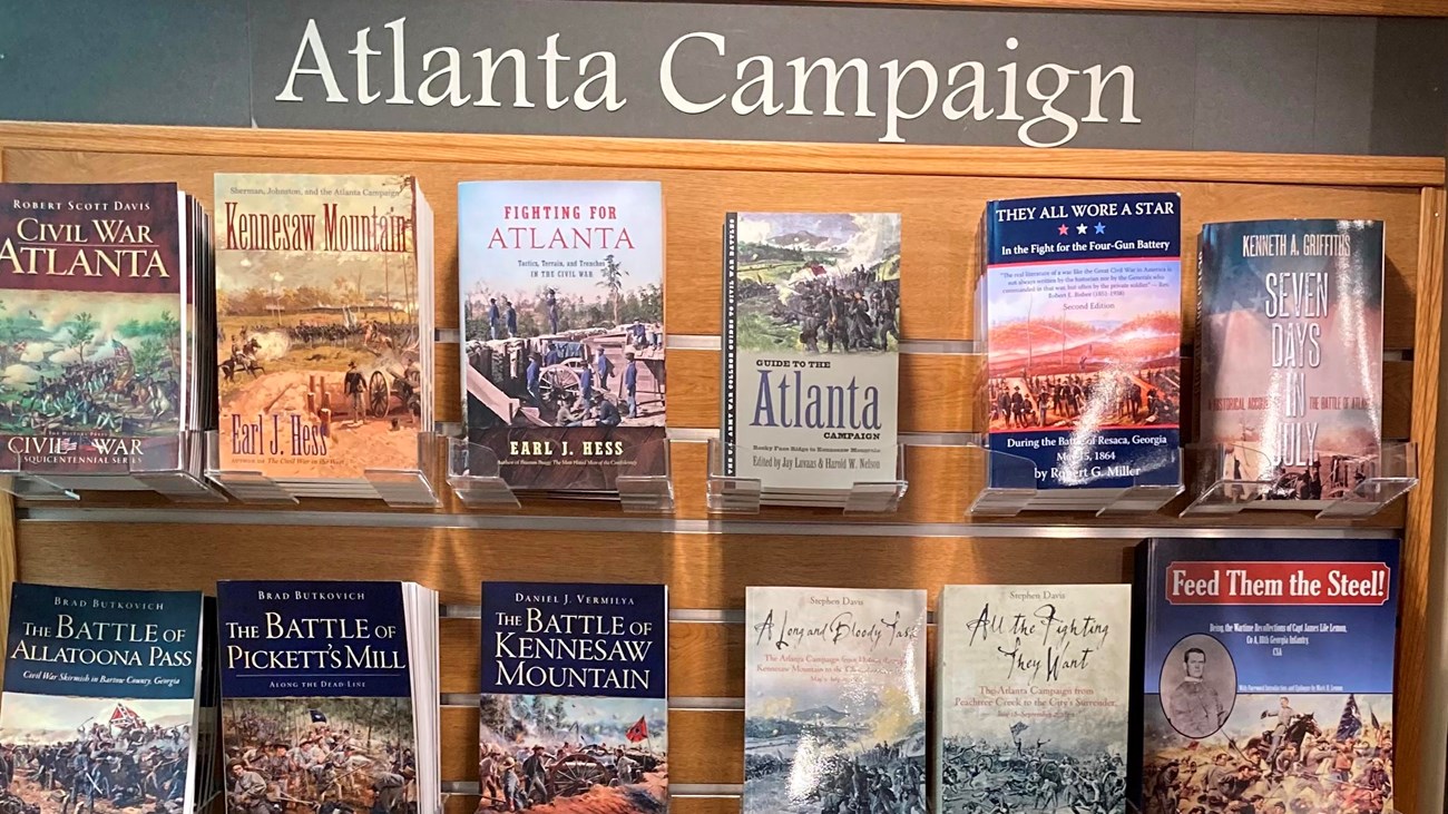 Wooden shelves stacked high with books on the subject of the Atlanta Campaign