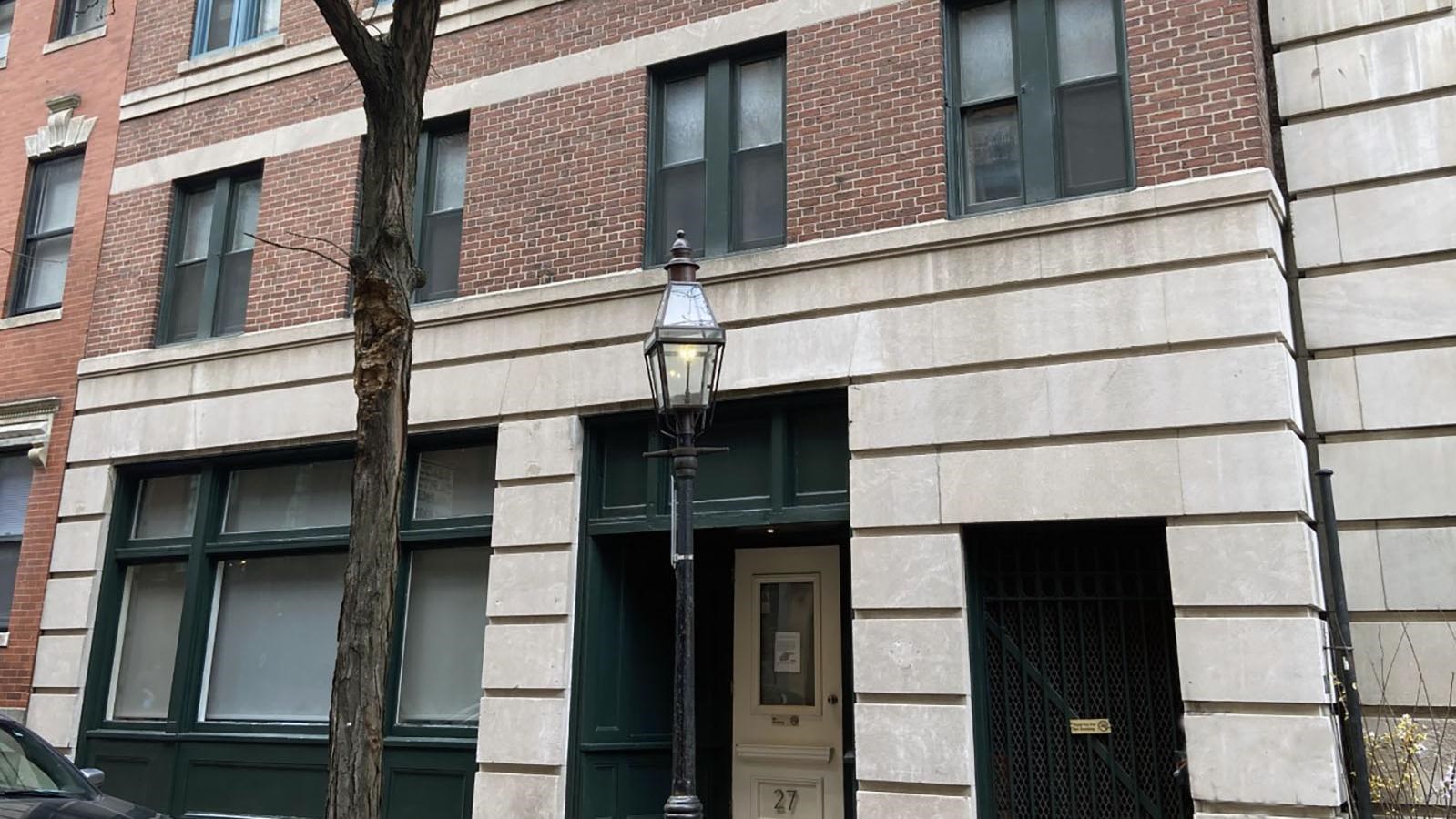 Beacon hill building with stone facade on first floor and brick on upper floors.