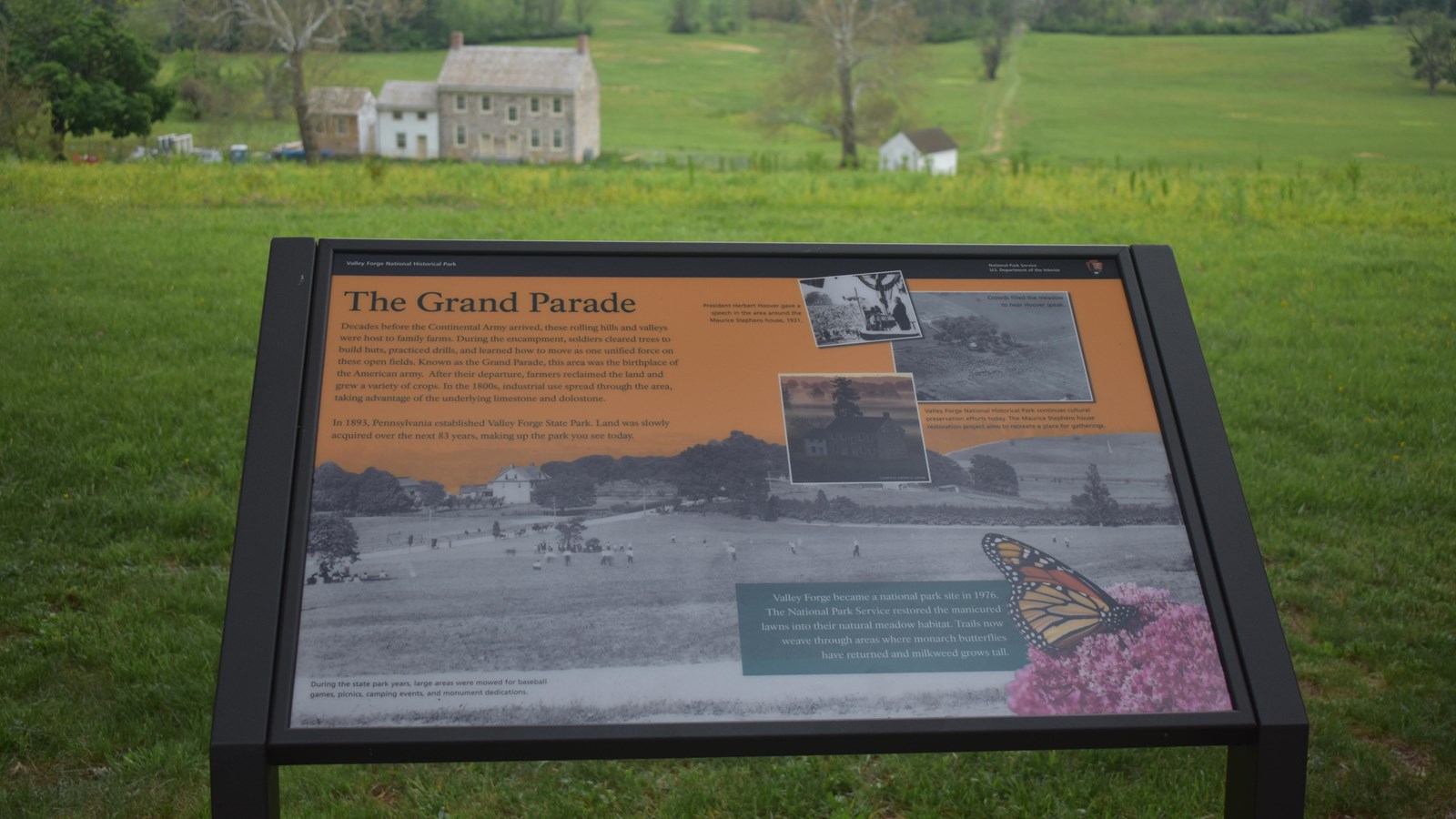 wayside exhibit panel showing historic photos of grand parade meadow